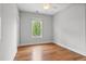 Light filled bedroom featuring hardwood floors, a ceiling fan, and a window overlooking trees at 6 Kirkland Ln, Charleston, SC 29401
