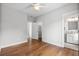 Bedroom features hardwood floors, neutral paint, ceiling fan, and a door leading to the bathroom at 6 Kirkland Ln, Charleston, SC 29401