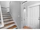 Entryway features wood stairs and an open door revealing a modern front door at 6 Kirkland Ln, Charleston, SC 29401