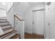 Modern entryway featuring wood stairs and a bright front door at 6 Kirkland Ln, Charleston, SC 29401