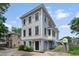 Charming three-story home featuring light-blue painted siding with a quaint front yard and well-kept landscaping at 6 Kirkland Ln, Charleston, SC 29401