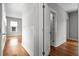 Bright hallway featuring hardwood floors, neutral paint, and white trim leading to open rooms at 6 Kirkland Ln, Charleston, SC 29401