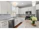 This modern kitchen features white cabinets, granite counters and stainless steel appliances at 6 Kirkland Ln, Charleston, SC 29401