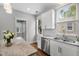 Eat-in kitchen has white cabinets, stainless appliances, granite counters, and wood floors at 6 Kirkland Ln, Charleston, SC 29401
