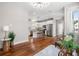 Bright open-concept living area with wood floors, modern lighting, and view of a white kitchen at 6 Kirkland Ln, Charleston, SC 29401