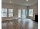 Sunlit living room boasts beautiful flooring, neutral paint, and a cozy fireplace at 1035 Tulip Shell St, Summerville, SC 29485