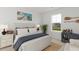 Bright bedroom features shuttered headboard, nautical decor, and a view to a home in the backyard at 1046 Scotch Bonnet Way, Summerville, SC 29485