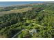 Stunning aerial view showcasing property's expansive land and proximity to marsh and beaches at 1064 Blackbear Dr, Edisto Island, SC 29438