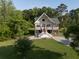 Aerial view of the property showcasing the lovely home, lush landscaping, and surrounding trees at 1064 Blackbear Dr, Edisto Island, SC 29438