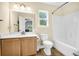 Bright bathroom featuring a wooden vanity, a window view and a bathtub/shower combination at 1064 Blackbear Dr, Edisto Island, SC 29438