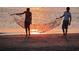 Silhouetted fishermen casting nets in the sunset ocean at 1064 Blackbear Dr, Edisto Island, SC 29438