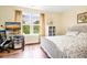 Cozy bedroom with ample natural light, light colored walls, and warm wood floors at 1064 Blackbear Dr, Edisto Island, SC 29438