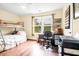 Well lit bedroom featuring warm wood floors, light walls, a large window, and a bunk bed at 1064 Blackbear Dr, Edisto Island, SC 29438