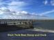 Scenic waterfront view with a State Park boat ramp and dock with cloudy skies at 1064 Blackbear Dr, Edisto Island, SC 29438