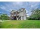 Exterior view of a house on stilts featuring well manicured grass and ample parking space at 1064 Blackbear Dr, Edisto Island, SC 29438