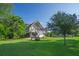 Charming raised beach house with a lush lawn and a well-maintained yard at 1064 Blackbear Dr, Edisto Island, SC 29438