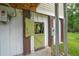 Exterior of the home with a charming barn-style door and modern LG dual inverter system at 1064 Blackbear Dr, Edisto Island, SC 29438