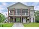 Exterior of raised home featuring a spacious lower level for parking and entertainment space at 1064 Blackbear Dr, Edisto Island, SC 29438