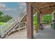 Exterior view of a home's stilts with a staircase and patio area at 1064 Blackbear Dr, Edisto Island, SC 29438