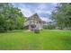 Charming home exterior with a well-maintained lawn, inviting porch, and a cute dog house at 1064 Blackbear Dr, Edisto Island, SC 29438