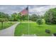 Expansive front yard with the American flag waving proudly, offering a peaceful setting at 1064 Blackbear Dr, Edisto Island, SC 29438