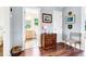 Hallway featuring hardwood floors, antique furniture, and a view into the neutral colored bathroom at 1064 Blackbear Dr, Edisto Island, SC 29438