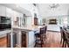 A modern kitchen with a large island, stainless steel appliances, and an open view to the living room at 1064 Blackbear Dr, Edisto Island, SC 29438