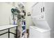 A tidy laundry room featuring a stacked washer and dryer and organized storage shelves at 1064 Blackbear Dr, Edisto Island, SC 29438