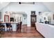 Open-concept living room with hardwood floors, kitchen island, and stainless steel appliances at 1064 Blackbear Dr, Edisto Island, SC 29438
