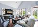 Bright living room with vaulted ceilings, comfortable seating, and entertainment center at 1064 Blackbear Dr, Edisto Island, SC 29438