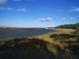 Beautiful marsh view with calm water and lush greenery, offering a serene and natural setting with clear blue skies above at 1064 Blackbear Dr, Edisto Island, SC 29438