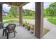 Inviting covered patio with outdoor seating and views of the beautifully landscaped yard at 1064 Blackbear Dr, Edisto Island, SC 29438