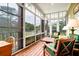 Relaxing screened porch with outdoor seating, wooden floors, and serene views of the surrounding landscape at 1064 Blackbear Dr, Edisto Island, SC 29438