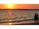 Sunset at the beach as a couple enjoys the beach at sunset with a beautiful skyline at 1064 Blackbear Dr, Edisto Island, SC 29438