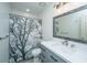 Modern bathroom with a gray vanity, decorative mirror, and patterned shower curtain at 110 Cantering Hills Ln, Summerville, SC 29483