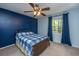 Comfortable bedroom with a ceiling fan, window, and blue accent wall at 110 Cantering Hills Ln, Summerville, SC 29483