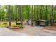 A green carport and outbuilding situated in a wooded area at 110 Cantering Hills Ln, Summerville, SC 29483