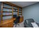 Built-in wooden desk with cabinets and shelving, plus a leather chair at 110 Cantering Hills Ln, Summerville, SC 29483