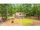 Two-story home boasting a two-car garage, screened-in porch, and lush green lawn surrounded by tall trees at 110 Cantering Hills Ln, Summerville, SC 29483