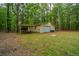 Detached yellow garage with carport nestled in the lush greenery at 110 Cantering Hills Ln, Summerville, SC 29483