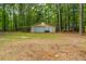 Detached garage in a wooded yard with trees and green grass at 110 Cantering Hills Ln, Summerville, SC 29483