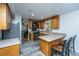 Cozy kitchen with warm wood cabinetry, stainless steel appliances, and an eat-in bar at 110 Cantering Hills Ln, Summerville, SC 29483