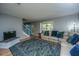 Comfortable living room with a large sectional, hardwood floors, and a staircase leading upstairs at 110 Cantering Hills Ln, Summerville, SC 29483