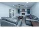 Comfortable living room featuring sleek gray couches, a fireplace, built-in shelving, and access to the patio at 110 Cantering Hills Ln, Summerville, SC 29483