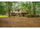 View of the back of this two-story home featuring a covered patio and brick accent at 110 Cantering Hills Ln, Summerville, SC 29483