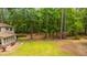 Overhead shot of a house with a patio and path in a wooded lot at 110 Cantering Hills Ln, Summerville, SC 29483