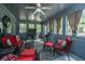 Sunroom features red wicker furniture, a ceiling fan, and lots of windows for natural light at 110 Cantering Hills Ln, Summerville, SC 29483