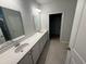 Well-lit bathroom with a double vanity and a view into a walk-in closet at 111 Brant Dr, Summerville, SC 29483
