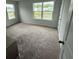 Bright bedroom showcasing carpet floors and multiple windows for ample natural light at 111 Brant Dr, Summerville, SC 29483