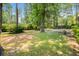 Lush green backyard with mature trees, offering shade and privacy at 113 Overhill Dr, Walterboro, SC 29488